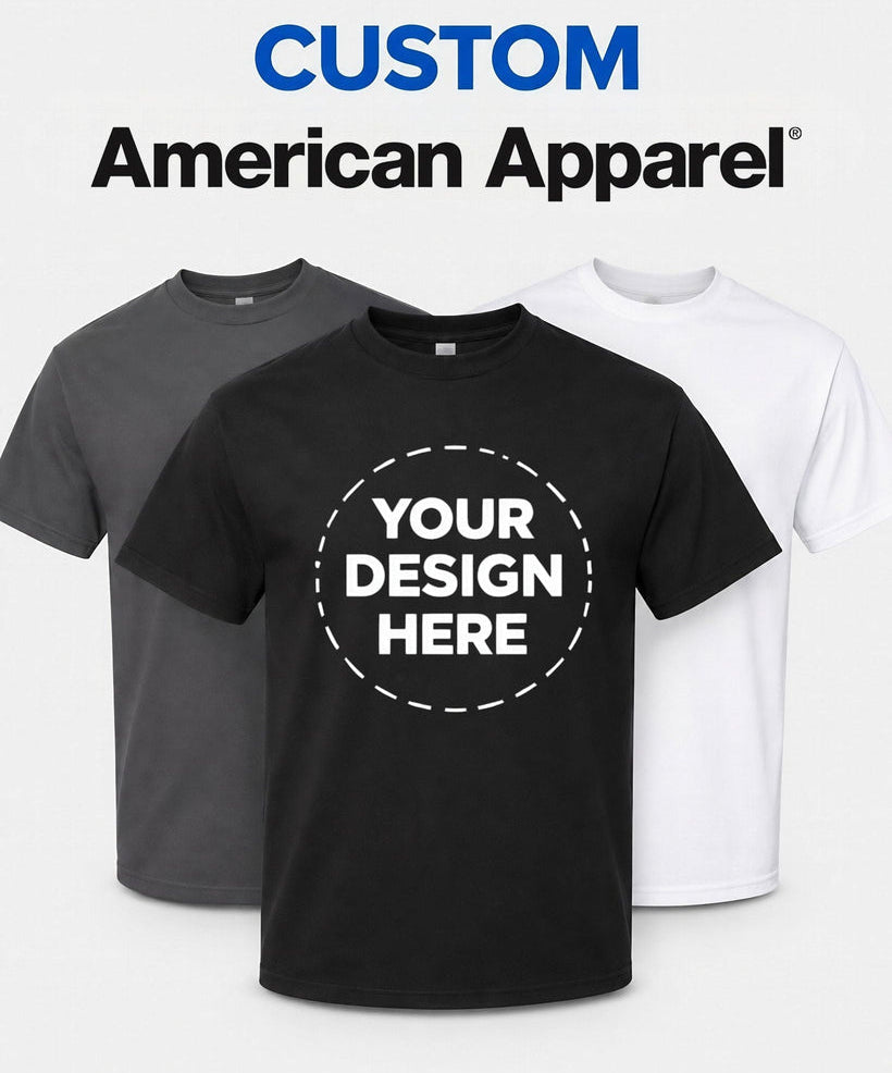 Three short-sleeve crew-neck t-shirts are shown on a light gray background: one black in front, one dark gray behind it, and one white behind it. Large text at the top reads 'CUSTOM American Apparel'.